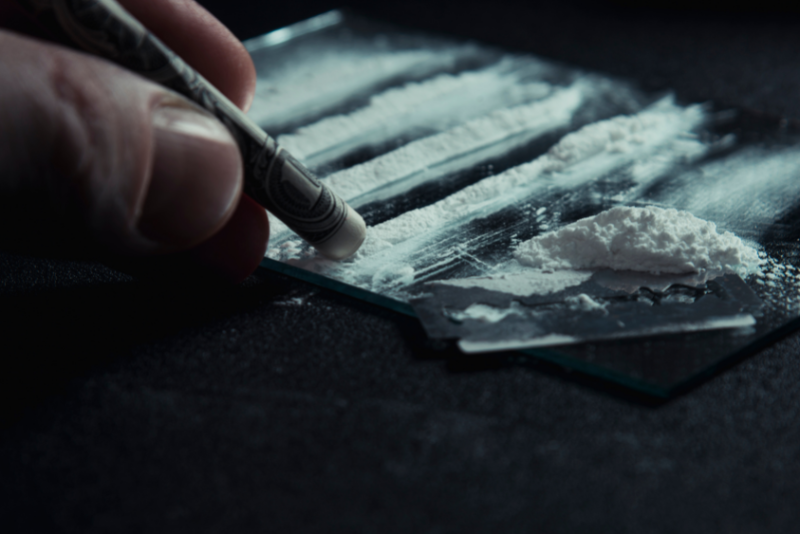 Closeup of someone using cocaine.