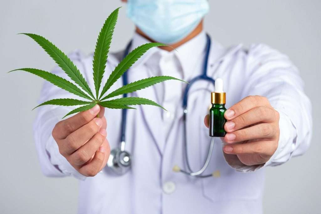 doctor holding cannabis plant & oil, weed detox