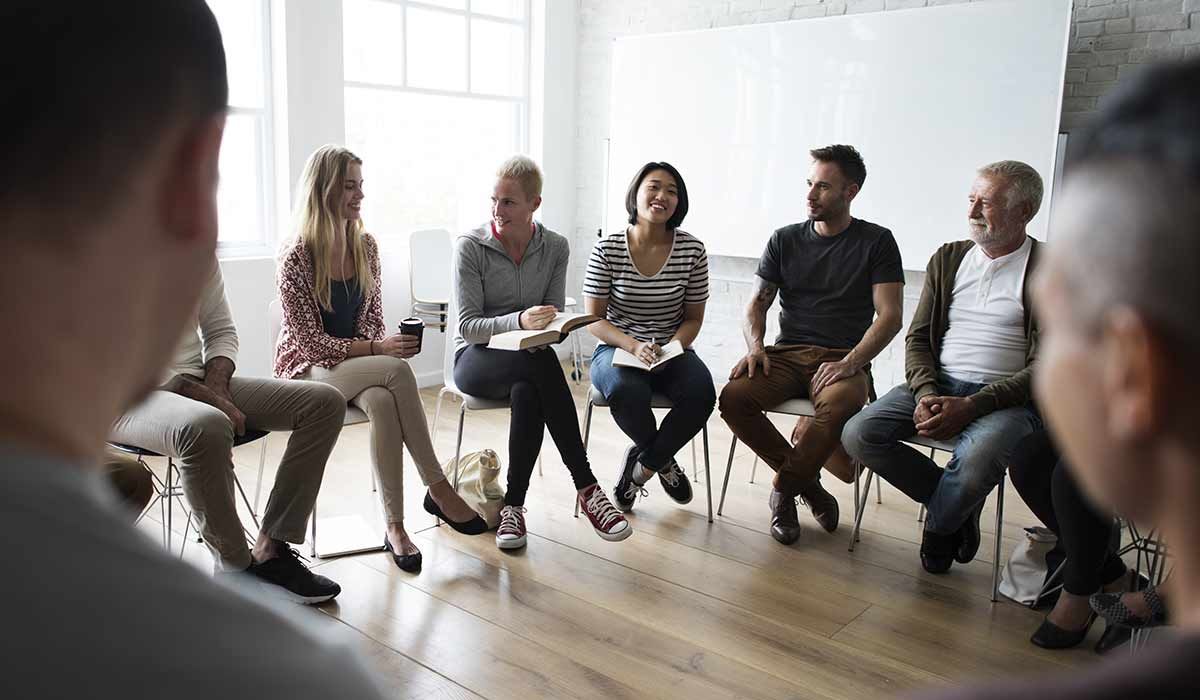 Addiction and mental health clients having group therapy