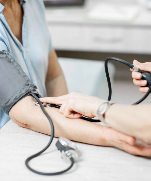 Nurse measuring patient's blood pressure. Addicted to heroin, Heroin addiction, Heroin Addiction treatment, heroin overdose, heroin withdrawal symptoms, What is heroin, Heroin addiction symptoms.